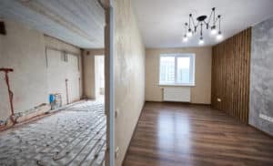 Two empty rooms with modern plastic window, heating radiators and heating inderfloor pipes before and after renovation. Comparison of old room and new renovated place with parquet, stylish chandelier